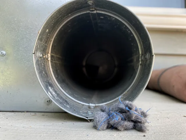 Lauderhill Dryer Vent Cleaning technician using specialized equipment to clear severe dryer vent blockage in Lauderhill